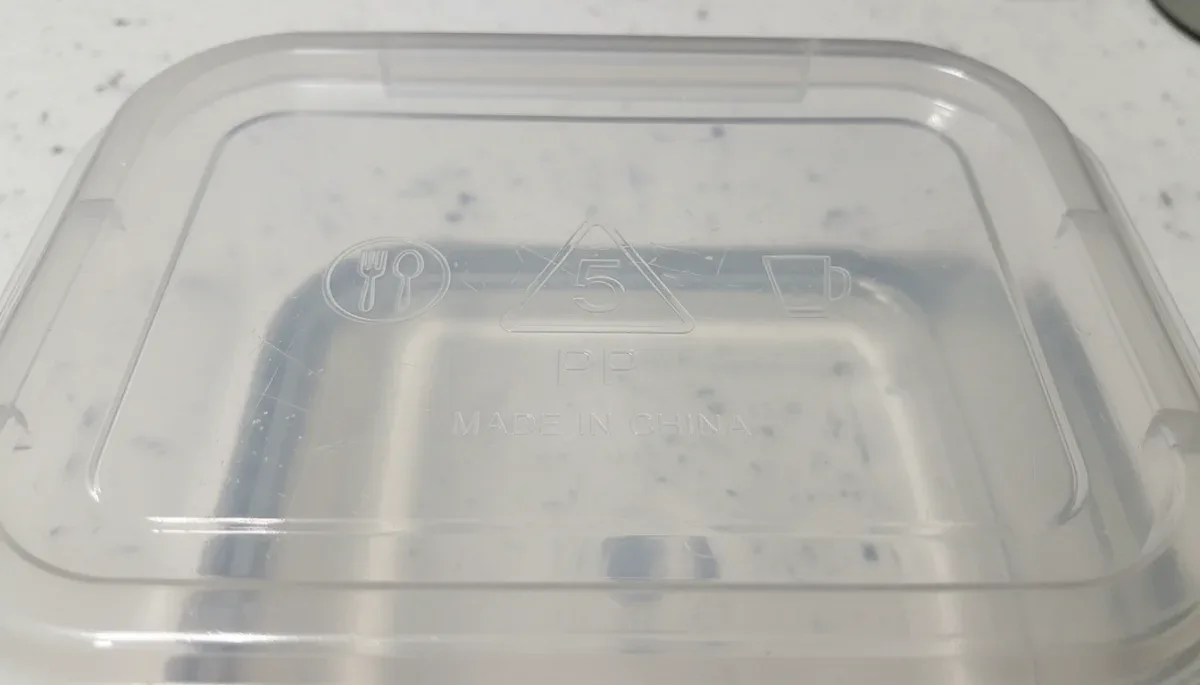 Food safety labels and plastic resin identification code stamped on food storage container