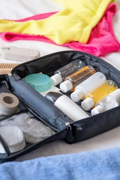 Close-up of a neatly packed carry-on suitcase, showcasing rolled clothing, travel-sized toiletries, and strategically placed accessories. The image highlights efficient packing techniques.
