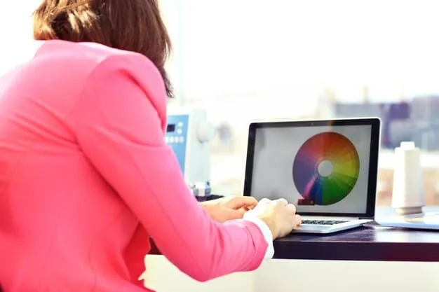 A person using a calibration software interface on a laptop connected to a projector, with vivid color charts and graphs displayed.