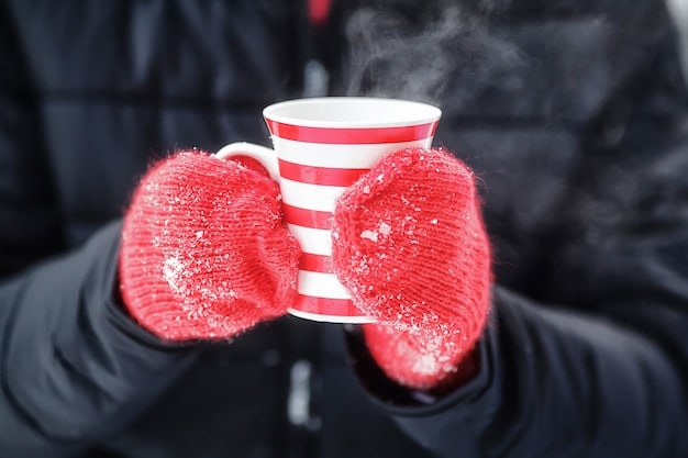 A close-up shot of a person's hands wearing thick, insulated gloves, holding a steaming cup of coffee in a snowy urban setting. The focus is on the texture and warmth of the gloves, highlighting their importance in winter.