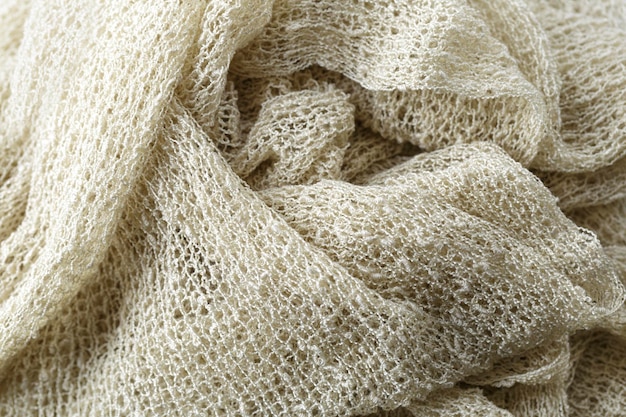 A close-up shot of various sustainable fabrics, including organic cotton, linen, and hemp. The textures and natural colors of the fabrics are highlighted, emphasizing their eco-friendly and earthy qualities. The image conveys a sense of quality, sustainability, and connection to nature.
