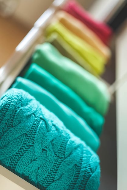A rack of clothing in a well-organized closet, showcasing various prints and patterns, including stripes, checks, florals, and animal prints, all thoughtfully curated to facilitate easy print mixing for creating diverse outfits.
