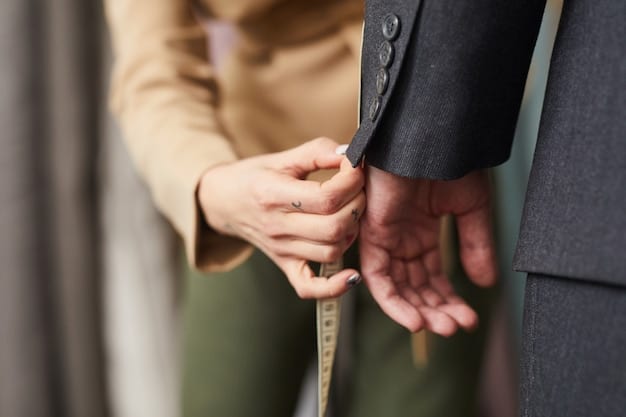 A close-up shot of a tailor's hands adjusting the hem of a pair of pants, with measuring tools visible in the background. The lighting is bright and focused on the details of the fabric and stitching.