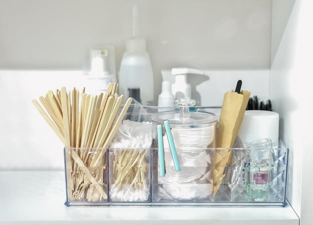 A well-organized bathroom drawer with clear plastic organizers. The organizers contain neatly arranged toiletries, makeup, and hair accessories.