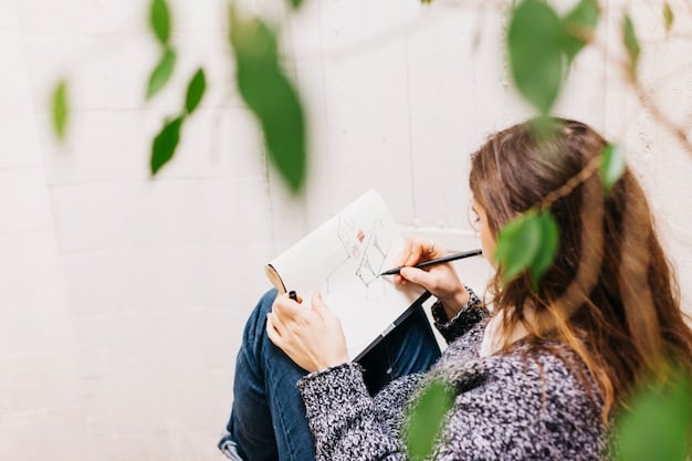A close-up shot of a person sketching landscaping ideas on a notepad while sitting at an outdoor table in a backyard. The notepad shows a rough sketch of a garden layout with different plant types and features.