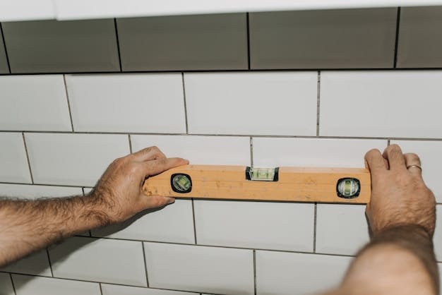 A homeowner installing new subway tile in their bathroom, showcasing a DIY renovation project that saves on labor costs.