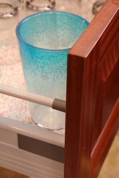 A close-up of corner cushions attached to the sharp edges of a coffee table to prevent injuries to children. The corner cushions are clear and discreetly placed.