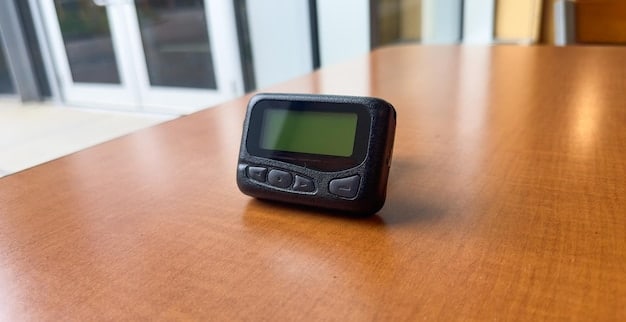 A digital sound meter displaying decibel levels being used in a home office setting.