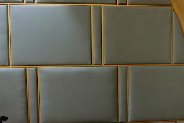 Close-up of soundproofing panels installed on a home office wall, highlighting the material and texture that help absorb sound.