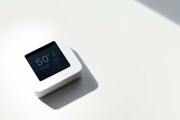 A close-up of a sleek, modern smart thermostat on a wall in a contemporary home, showing a digital display with temperature and energy usage statistics, symbolizing efficiency and control.