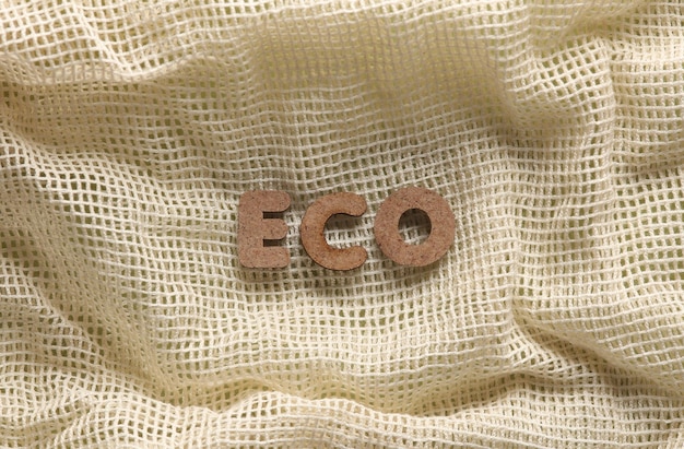 A close-up of a garment label featuring multiple sustainability certifications like GOTS, Fair Trade, and B Corp logos, against a soft fabric background.
