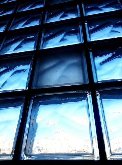 A close-up shot of a triple-pane window cross-section, clearly showing the three layers of glass and the gas-filled spaces in between, highlighting the advanced insulation technology.