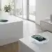 Modern home with devices wirelessly charging on surfaces and over-the-air.